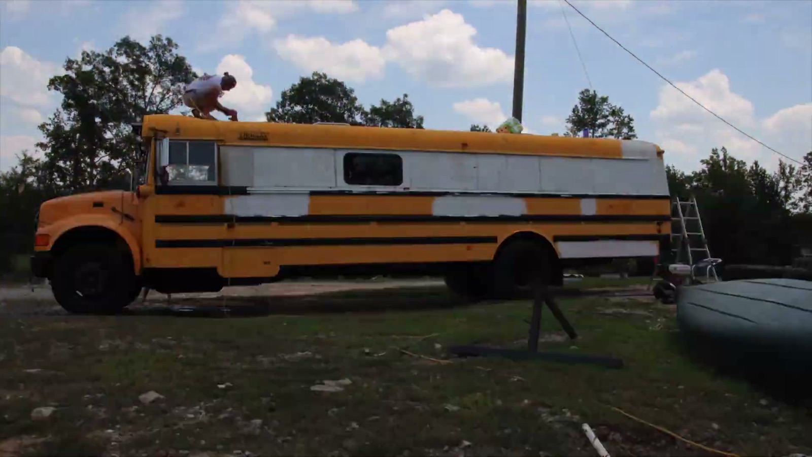 Matt working on the roof of the family's school bus conversion